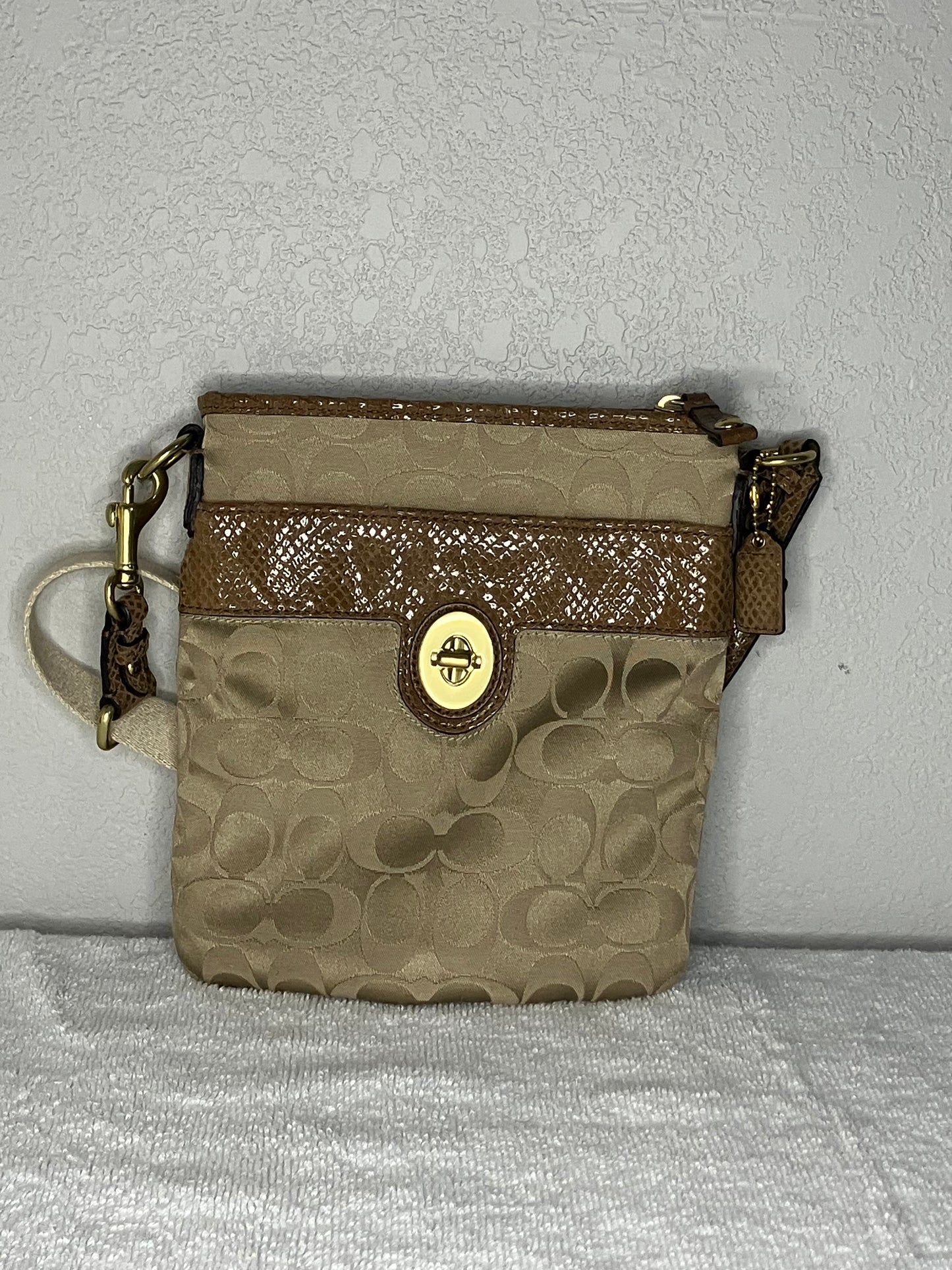 Coach Signature Swingpack Crossbody Bag with a Turnlock Closure and Brown Snakeskin-like Trim